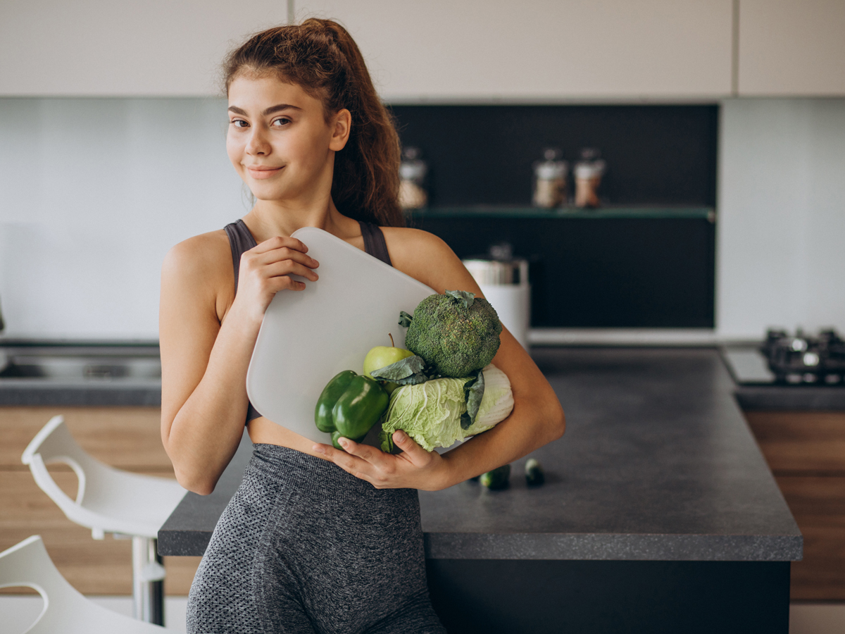 young-sporty-woman-with-scales-vegetables-kitchen